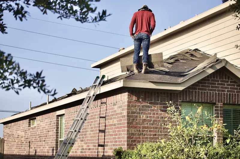 Professional roofer working on a residential roof in Madison